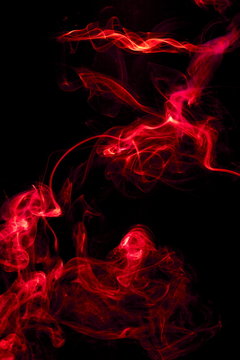 Red smoke on black background