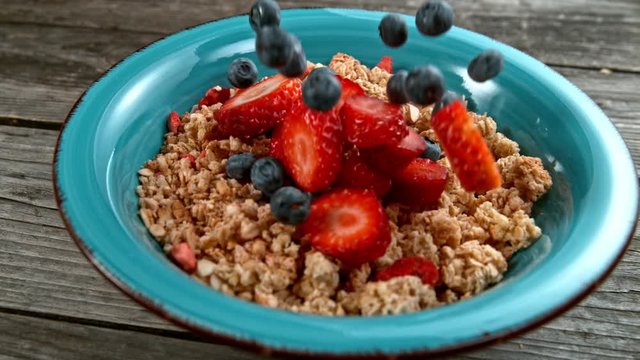 Fruit falling to cereals bowl in super slowmotion.