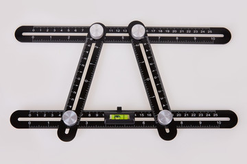 Black multi function Ruler isolated on white background. Ultimate Irregular Shape Copy Tool....