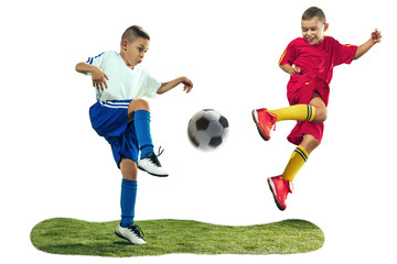 Young boys kicks the soccer ball. Isolated photo on white background. Football players in motion on studio background. Fit boys in action, jump, movement at game.