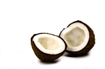 broken coconut into two parts on a white background