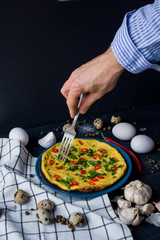 Homemade omelette on plate with hand. Healthy food concept.