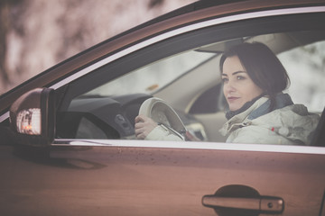 Pretty, young woman  driving a car -Invitation to travel. Car rental or vacation.