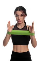 athletic girl with a rubber band for fitness on isolated background