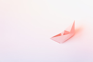 pastel color paper boat on clean background with copy space, learning and education concept