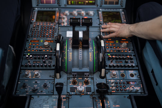 Pilot's Hand Dialing In Flight Values In  A Commercial Airliner Airplane Flight Cockpit During Takeoff