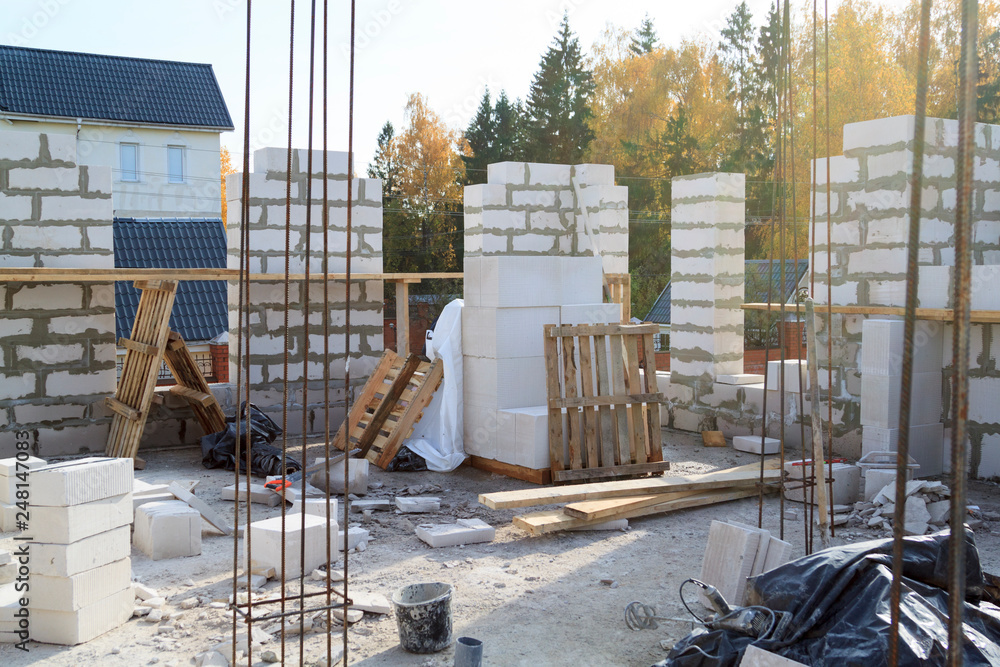 Poster view of laying walls of first floor, fittings for filling supporting columns. construction of countr