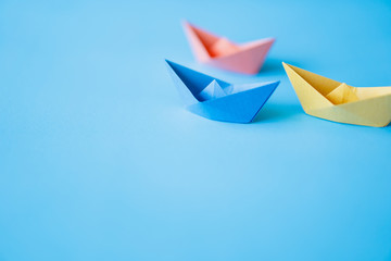 pastel color paper boat on clean background with copy space, learning and education concept