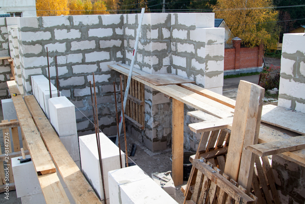 Poster view of laying walls of first floor, fittings for filling supporting columns. construction of countr