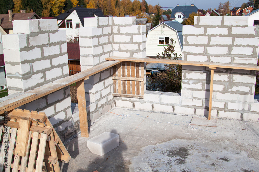 Poster view of laying walls of first floor, fittings for filling supporting columns. construction of countr