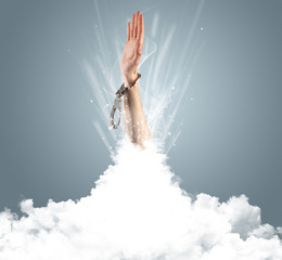 Naklejka premium Hand breaking out from cloud 