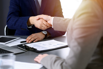 Business people shaking hands, finishing up a meeting. Papers signing, agreement and lawyer consulting concept