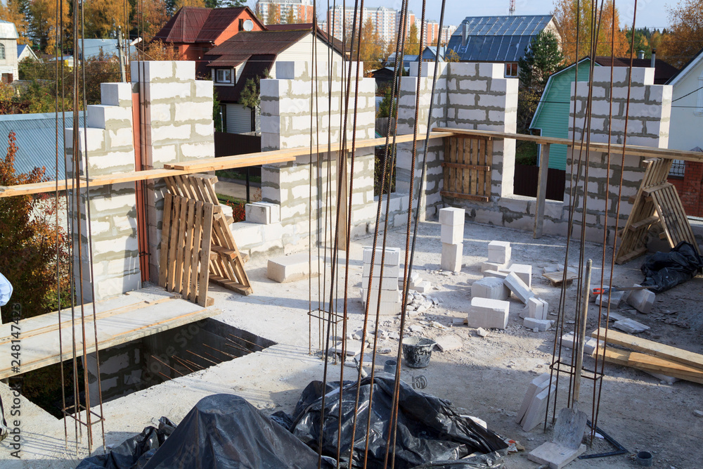 Poster view of laying walls of first floor, fittings for filling supporting columns. construction of countr