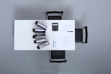 Binders with papers are waiting to be processed with bookkeeper. Internal Revenue Service inspector...
