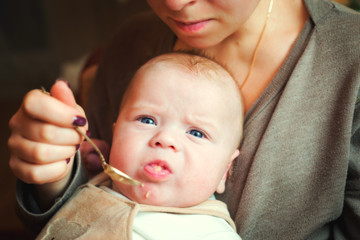 Mother feeding her happy little cute son, motherhood, relationship, happy family