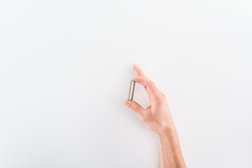 Cropped view of man holding battery on grey background