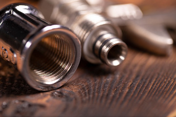tools plumbing on a dark woody background. tinting. selective focus