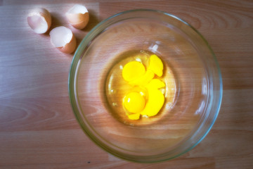 Raw eggs in a glass bowl