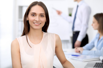 Portrait of a young business woman  at meeting. Negotiation concept