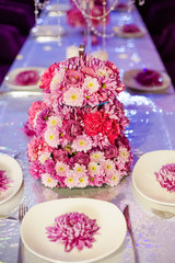 Wedding party table flowers on the table. Pink pions and wite chrysanthemums