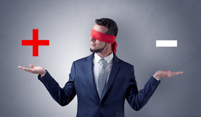 Covered eye businessman choosing between two directions 