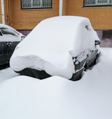 Auto covered with snow in winter
