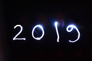 New Year 2019 on a black background. Concept light