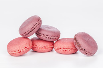 Delicious four pink macarons or macaroons isolated on a white background