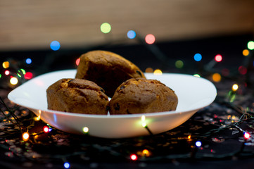 Festive cupcakes with raisins on a black background.