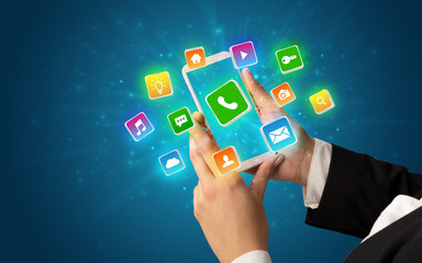 Female hand using smartphone with 3D shiny starlike application icons around
