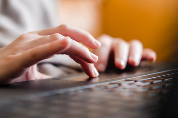 Woman hands are writing something on the black keyboard. 