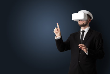 Businessman with white vr glasses in an empty room with no wallpaper
