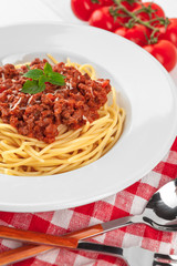 Pasta with meat, tomato sauce and vegetables on the table