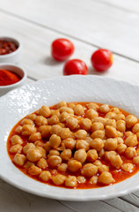 Vegetarian tasty spicy chick pea soup on a wooden background / Cheakpea stew/ Turkish nohut pilaki 