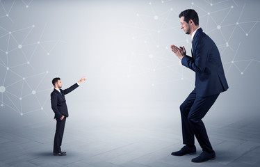 Small businessman aiming at a big businessman with connection and network concept
