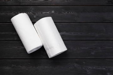 Roll of paper towel on wooden background