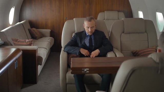 Businessman inside of private jet luxury interior