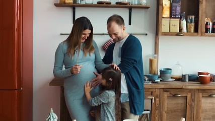 Pregnant woman husband and daughter in the kitchen - Powered by Adobe