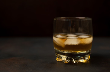 Whiskey with ice on concrete