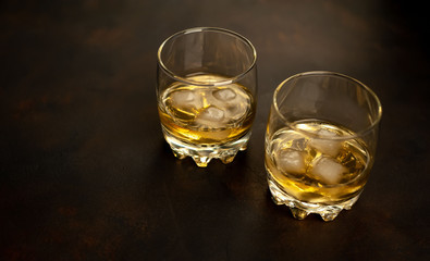 Whiskey with ice on concrete