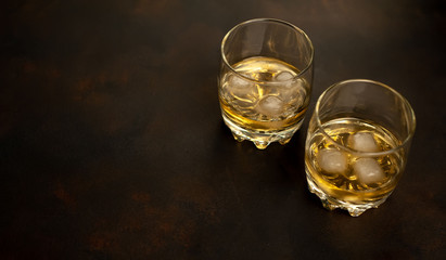 Whiskey with ice on concrete