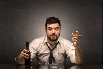 Young drunk man at his office with free dark copyspace