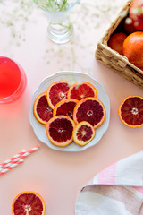 Glass of fresh blood orange juice on pink background. Selective focus
