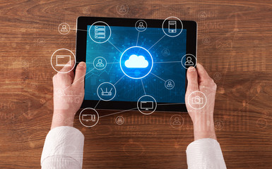 Hand touching tablet with cloud computing and online storage concept
