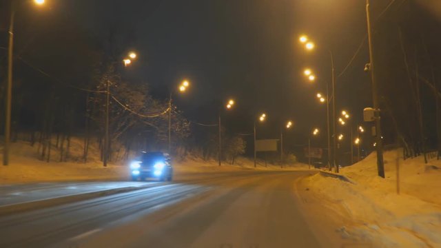 Samara, Russia - January 30, 2019: Cars drive on the night winter road