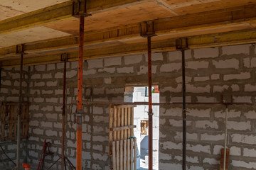 close up view of the wooden formwork with metal holders, which will be filled with the overlap...