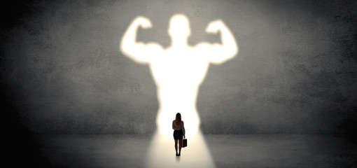 Woman standing and dreaming about a strong superhero