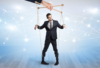 Puppet businessman controlled by another hand with financial concept
