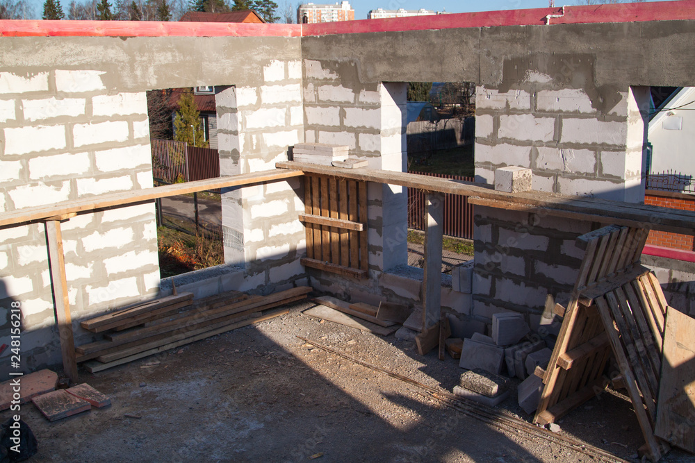 Poster view of laying walls of first floor, fittings for filling supporting columns. construction of countr