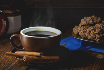 Steaming Cup of Coffee With Cinnamon Sticks